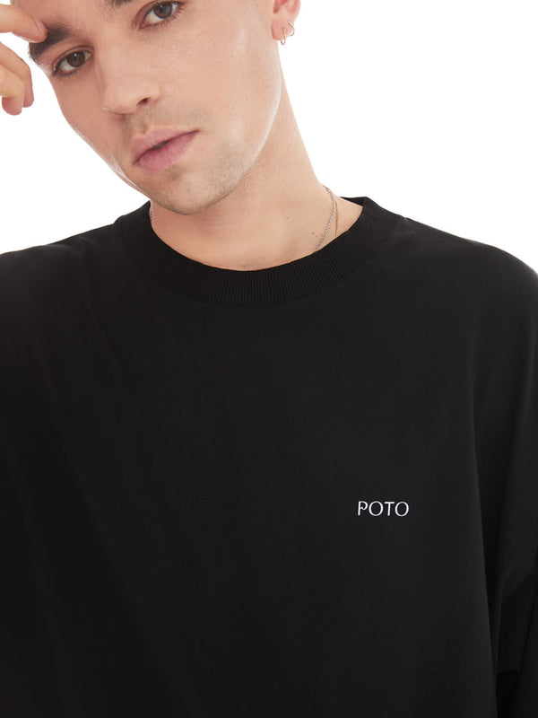 detail of model in relax pose using black oversized upcycled t-shirt with print