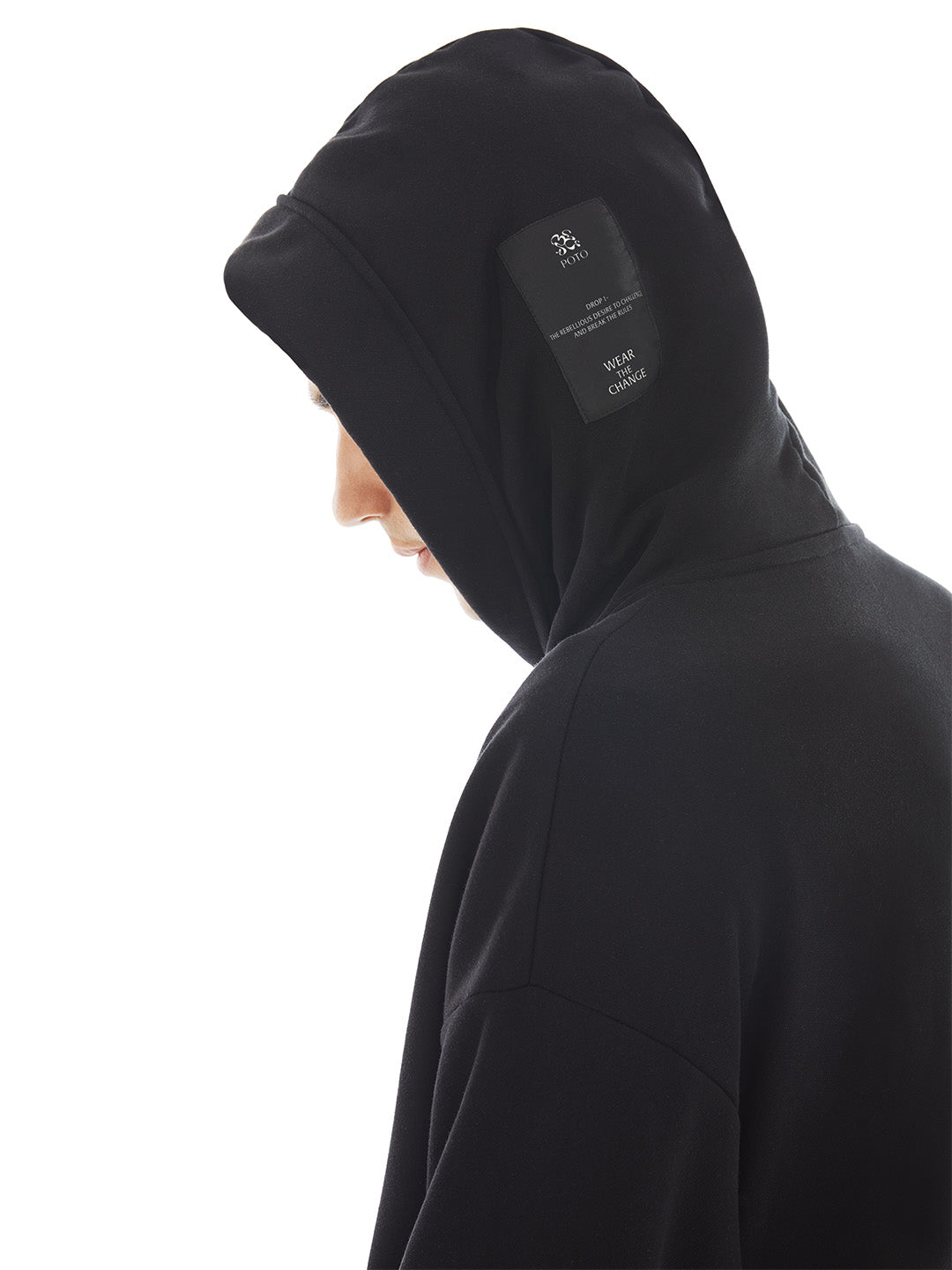hood of black poncho with brand tag on the side