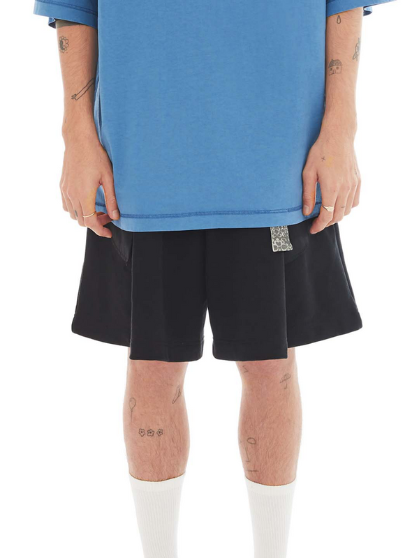 Black tailored shorts with exposed pockets. 