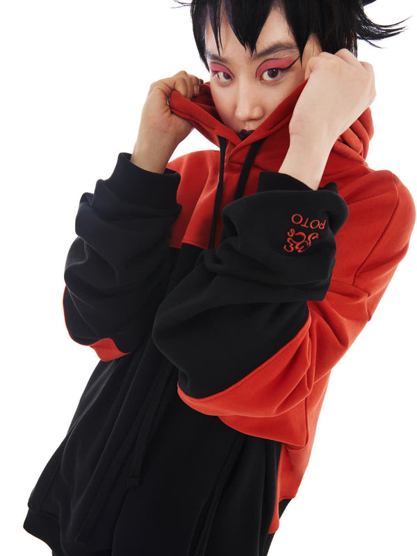 model with coral and black upcycled hoodie made from organic cotton